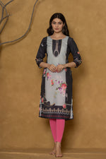 Back view of the rich black pannel kurta, showing the elegant fall and the subtle continuation of the floral patterns.