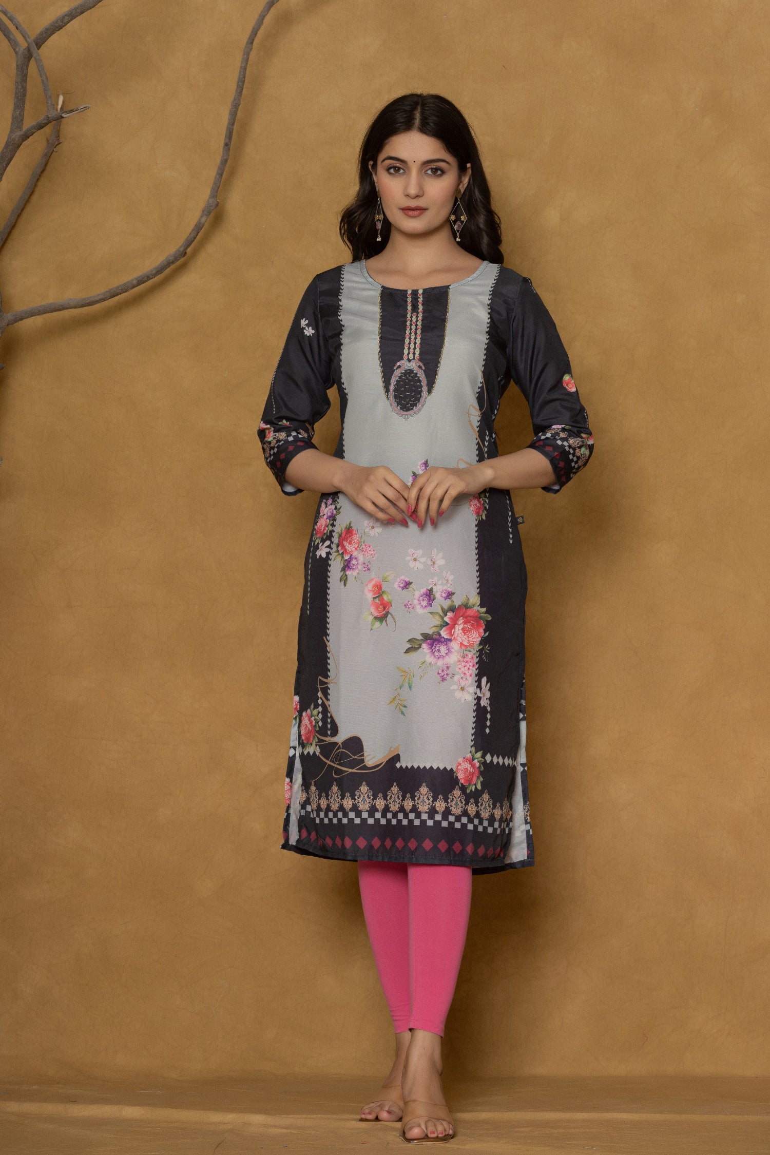 Back view of the rich black pannel kurta, showing the elegant fall and the subtle continuation of the floral patterns.