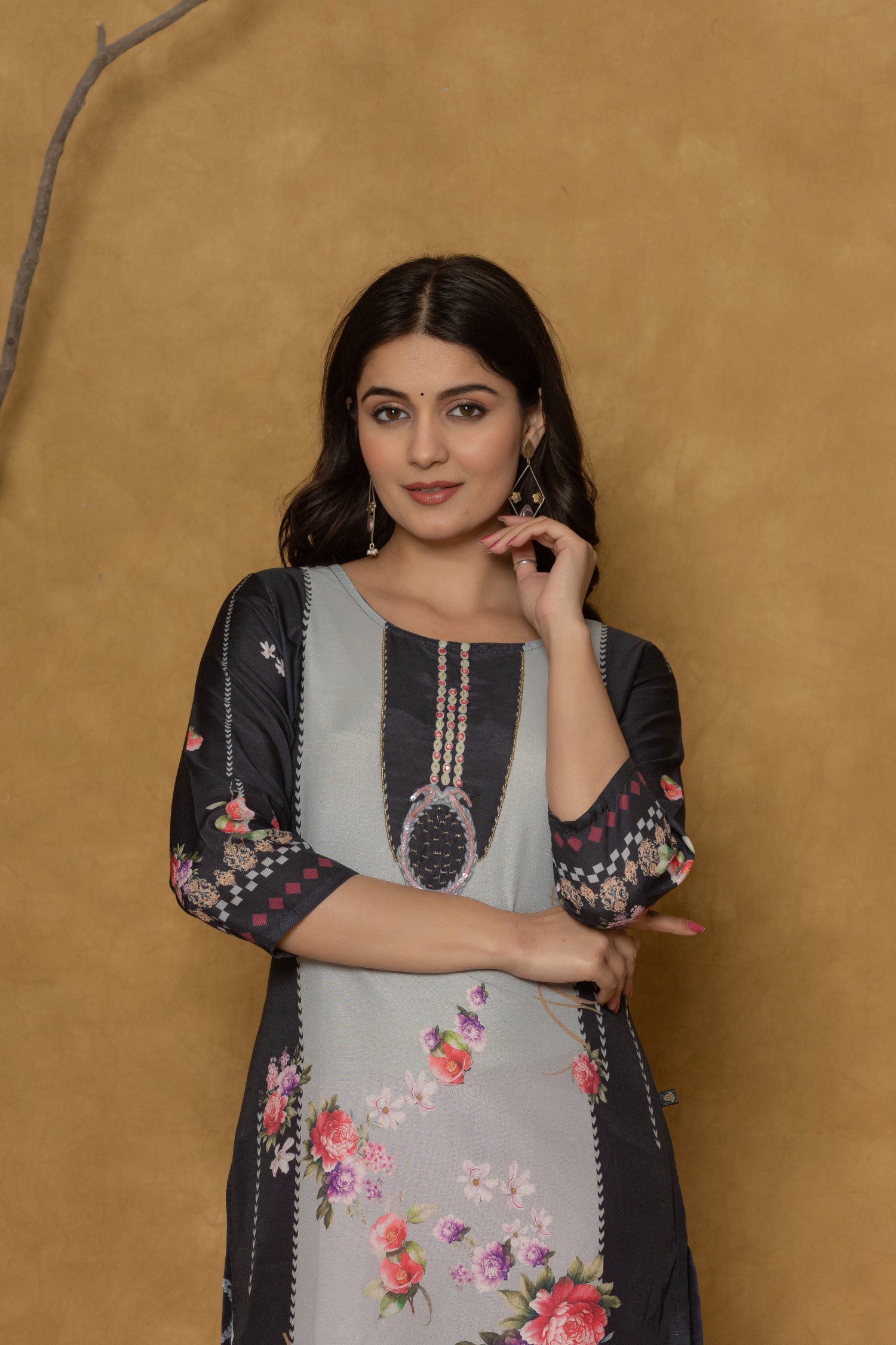 Side profile of model showcasing the modern cut and comfortable fit of the rich black pannel kurta with floral details.