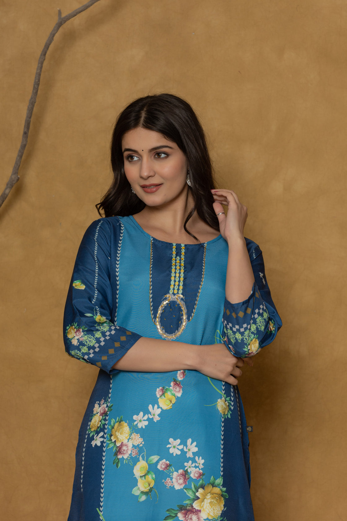 Side profile of model showcasing the comfortable fit and elegant floral design of the blue kurta with handwork detailing.