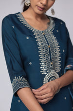 Close-up of the delicate white thread embroidery on the sleeves and cuffs of the blue soft silk kurta.