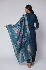 Side profile of model showcasing the elegant drape of the printed jacquard dupatta and the comfortable movement of the blue soft silk suit set.