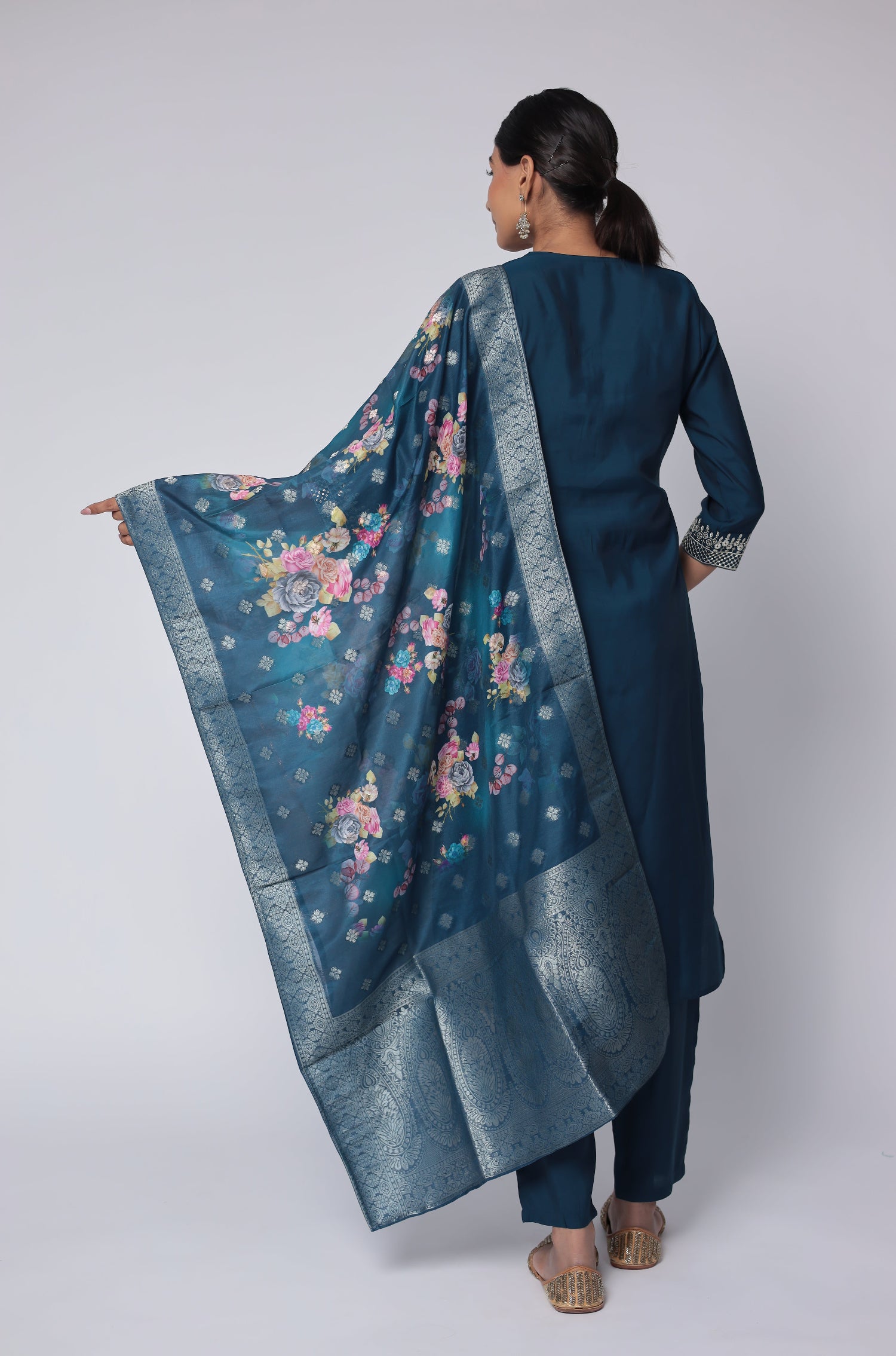 Side profile of model showcasing the elegant drape of the printed jacquard dupatta and the comfortable movement of the blue soft silk suit set.