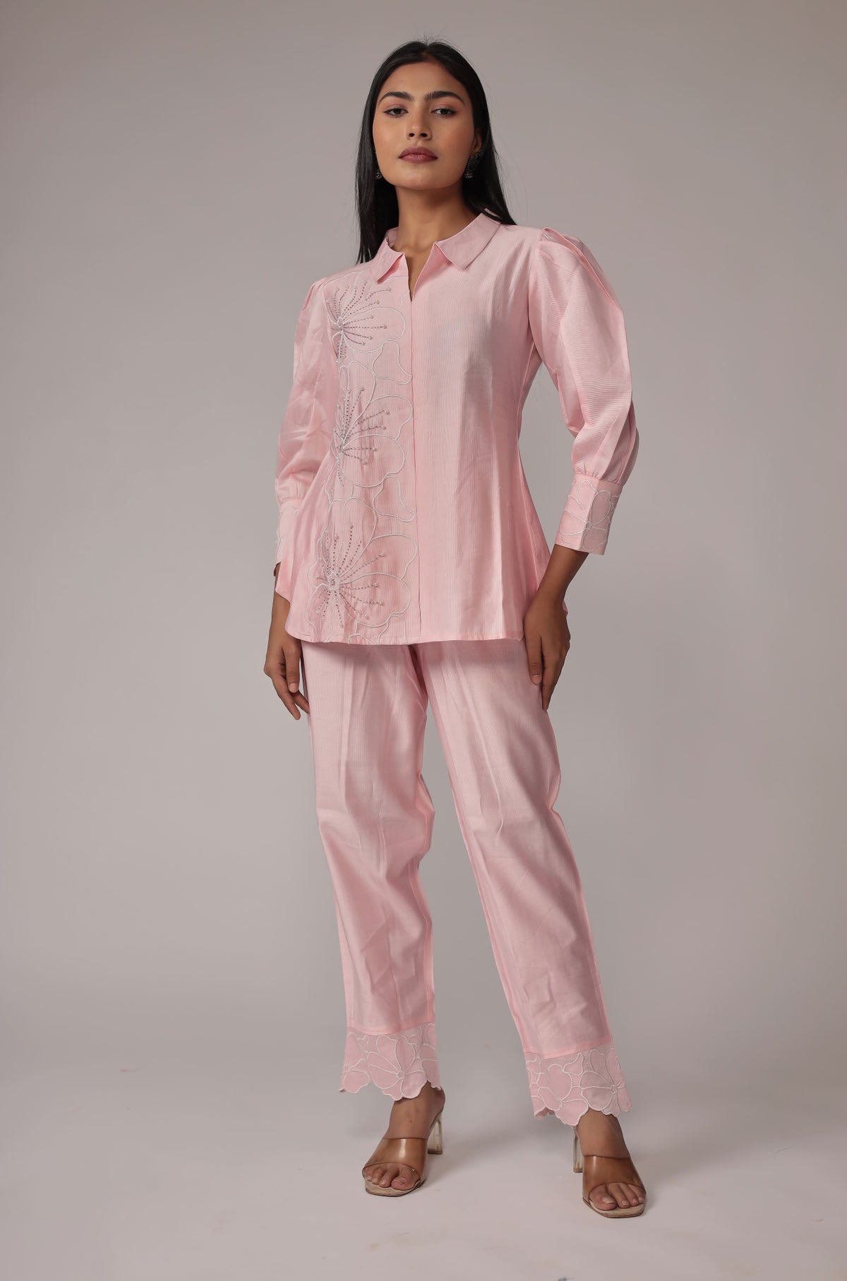 Model wearing a classy and stylish pink co-ord set from The Navra, featuring creative work details on the top and comfortable matching pants. Ideal for modern casual or semi-formal occasions.