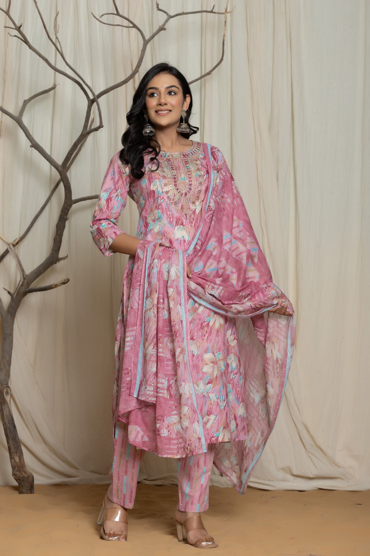 Model wearing a light pink cotton premium mill print dupatta set from The Navra, featuring multicolor abstract prints and delicate embroidery detailing on the neckline. Paired with a flowing printed dupatta and matching pants, ideal for comfortable daily or casual wear.