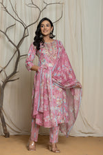 Model wearing a light pink cotton premium mill print dupatta set from The Navra, featuring multicolor abstract prints and delicate embroidery detailing on the neckline. Paired with a flowing printed dupatta and matching pants, ideal for comfortable daily or casual wear.