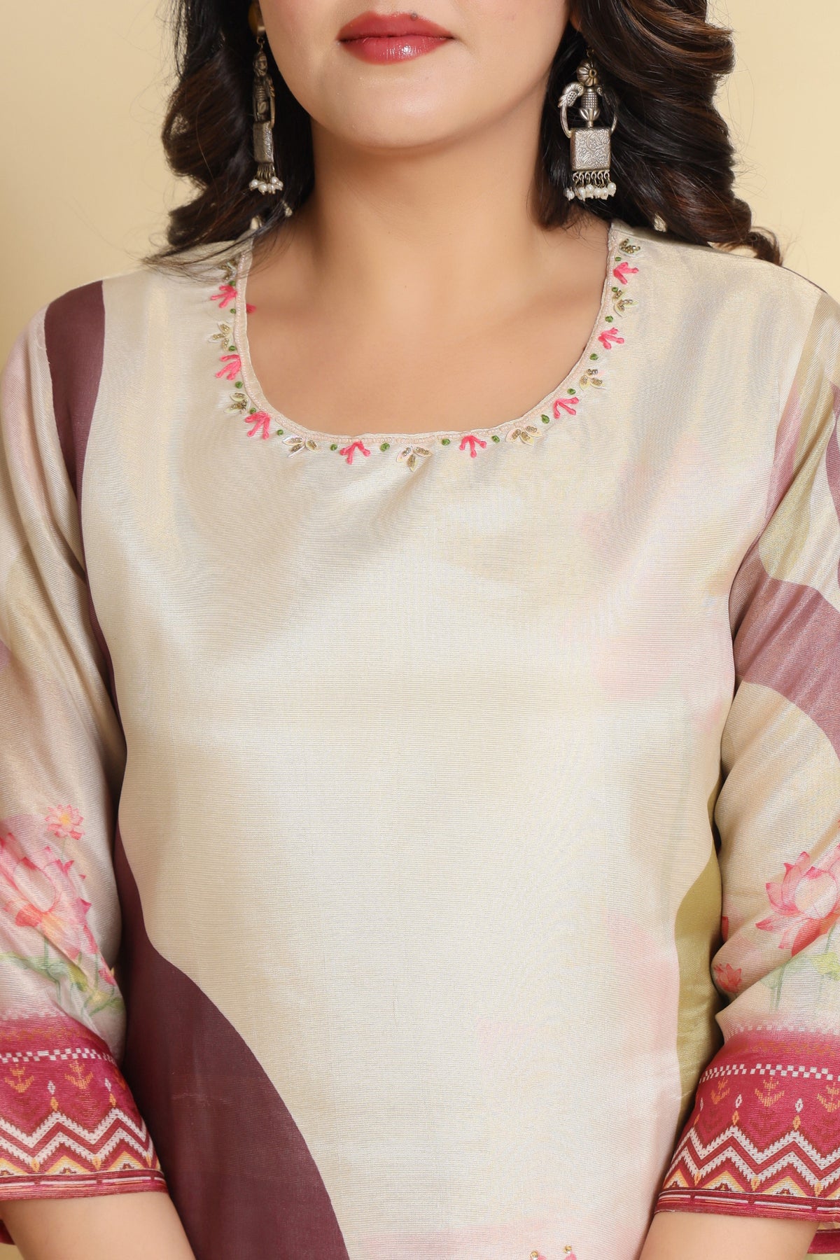 Close-up of the elegant neckline and the subtle digital print on the cream kurti, highlighting the design details.