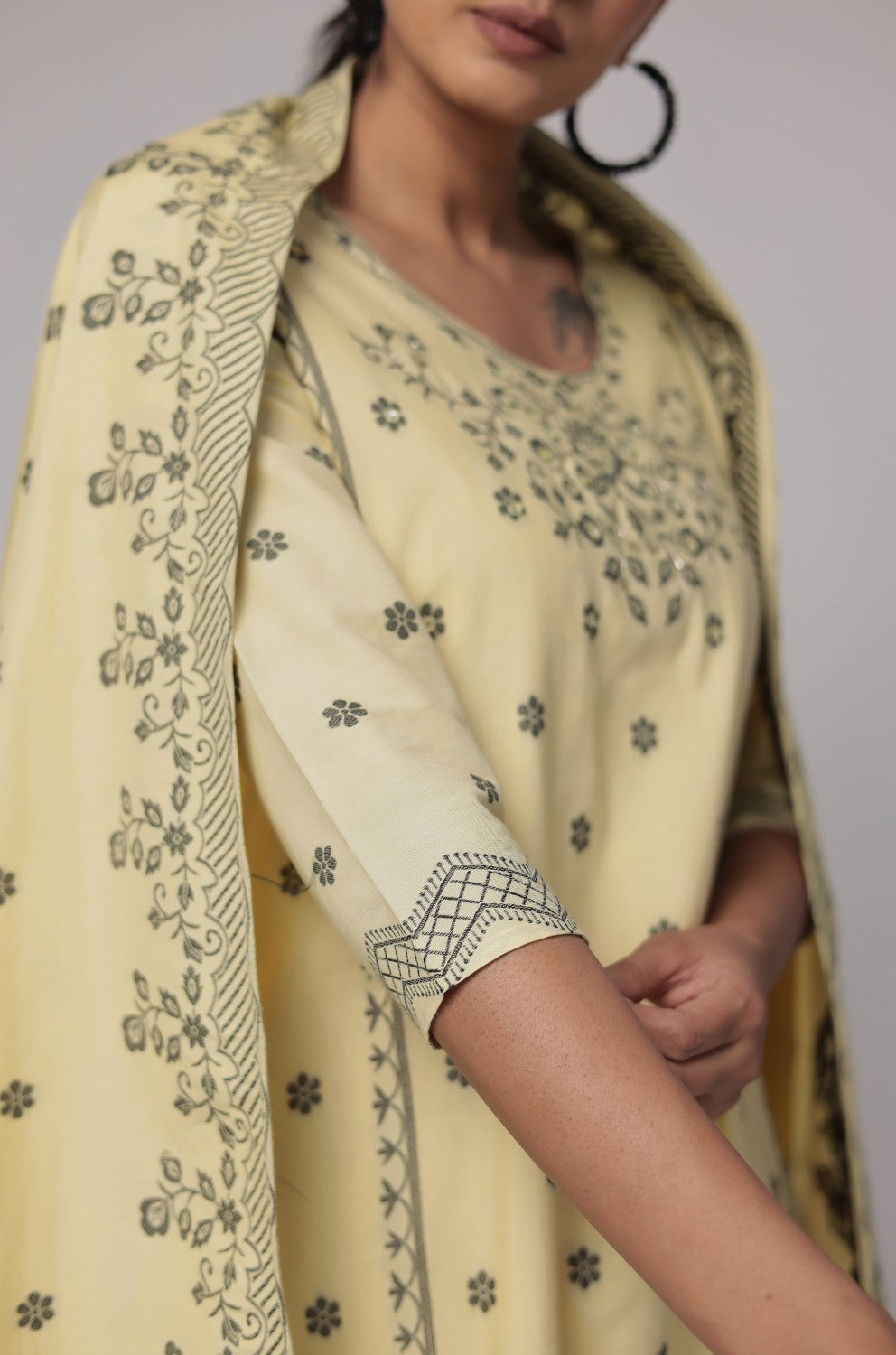 Model in a confident stance, highlighting the full length and overall elegant design of the cream yellow cotton jacquard dupatta set with merging embroidery.