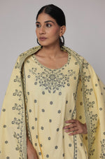 Model gracefully posing in the cream yellow cotton jacquard dupatta set, showcasing the comfortable movement and elegant flow of the patterned dupatta.