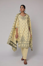 Side profile of model showcasing the comfortable fit and elegant drape of the cream yellow cotton jacquard dupatta set with merging embroidery.