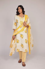 Side profile of model showcasing the comfortable fit and elegant Jaipuri print of the cream and yellow kurta set with mulmul lining.