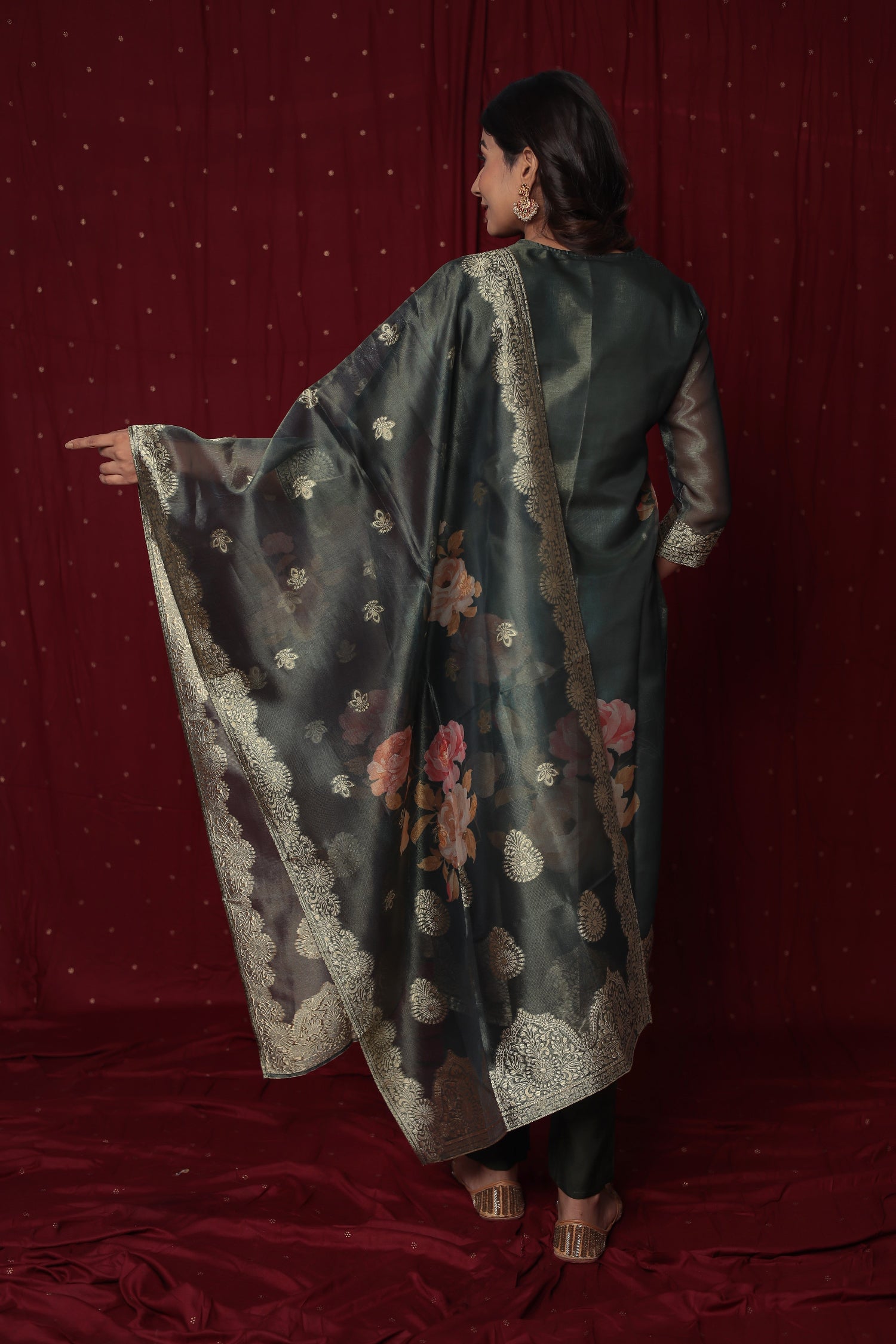 Back view of the deluxe dark green jacquard suit, showing the elegant fall of the fabric and the gold woven design.