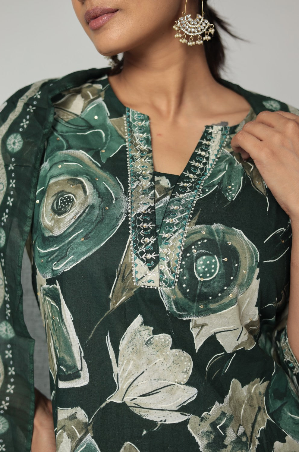 Close-up of the delicate handwork and beads work embroidery on the round neckline of the dark green Jaipuri print kurta, highlighting intricate details.