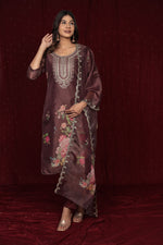 Flat lay arrangement of the complete deluxe shimmer organza brown suit set, highlighting the shimmer effect of the fabric and the details of the kurti, dupatta, and pant.