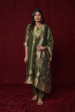 Flat lay arrangement of the complete deluxe jacquard organza olive green suit set, including the woven kurti, matching jacquard dupatta, and soft silk pant.