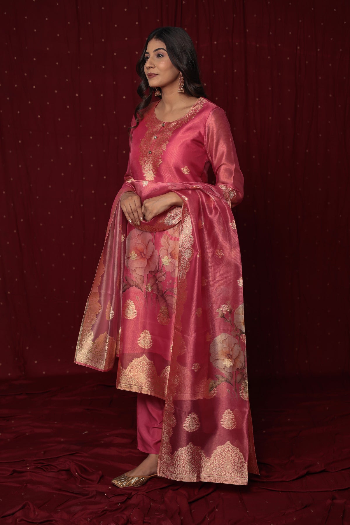 Flat lay arrangement of the complete deluxe jacquard organza pink suit set, highlighting the rich fabric texture and woven patterns of the kurti and matching dupatta.