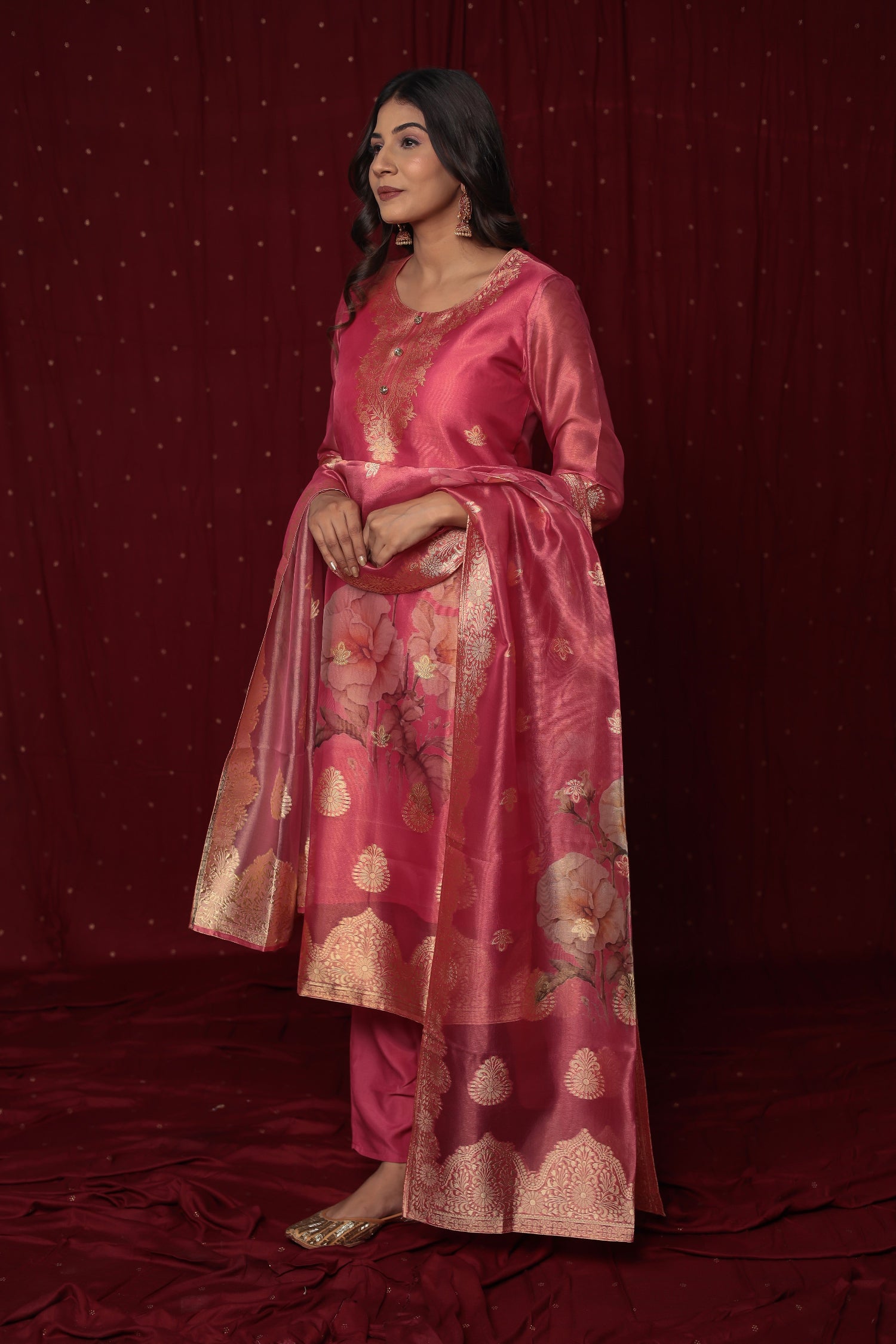 Flat lay arrangement of the complete deluxe jacquard organza pink suit set, highlighting the rich fabric texture and woven patterns of the kurti and matching dupatta.