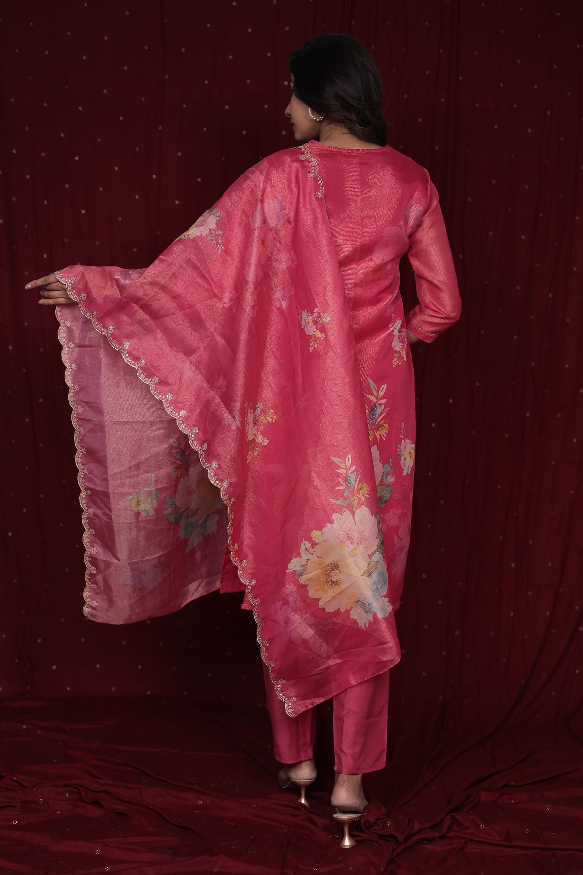 Flat lay arrangement of the complete deluxe shimmer organza pink suit set, including the embroidered kurti, floral dupatta, and soft muslin pant
