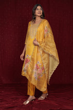 Back view of the deluxe shimmer organza yellow suit, showing the elegant drape and the soft muslin pant.