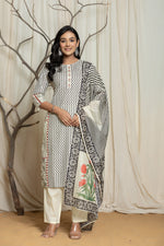 Model wearing an elegant English grey and off-white Lapet fine digital print dupatta set from The Navra, featuring handwork detailing on the zigzag-patterned kurta and a floral printed dupatta. Ideal for comfortable daily or semi-formal ethnic wear.