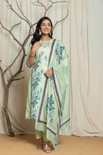 Model wearing an elegant pistachio green Lapet fine digital print dupatta set from The Navra, featuring handwork detailing on the floral and geometric patterned kurta and a matching floral border dupatta. Ideal for comfortable daily or semi-formal ethnic wear.