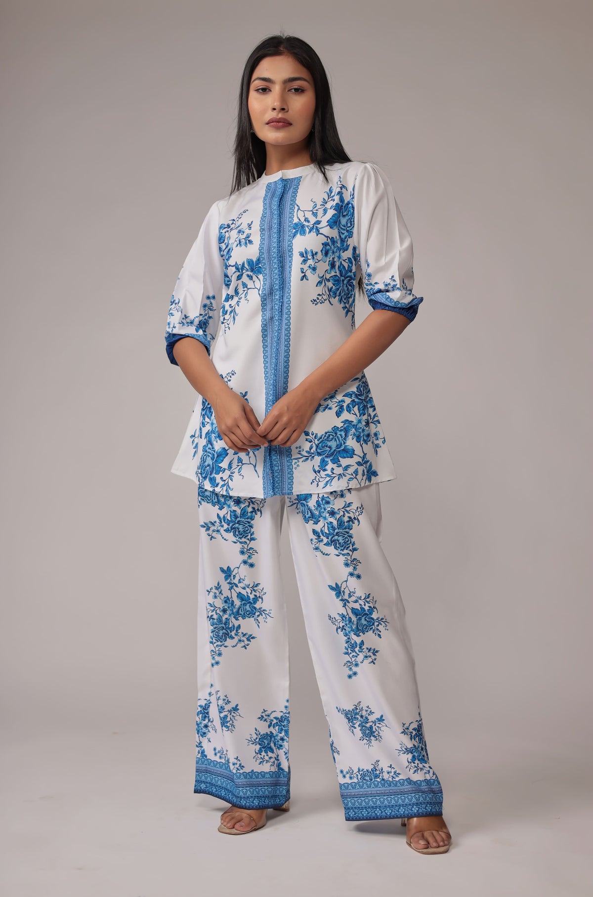 Model wearing an elegant white co-ord set from The Navra, featuring a stunning royal blue digital print kurta and matching wide-leg pants. Perfect for stylish casual or semi-formal occasions.
