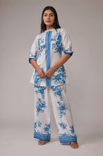 Model wearing an elegant white co-ord set from The Navra, featuring a stunning royal blue digital print kurta and matching wide-leg pants. Perfect for stylish casual or semi-formal occasions.