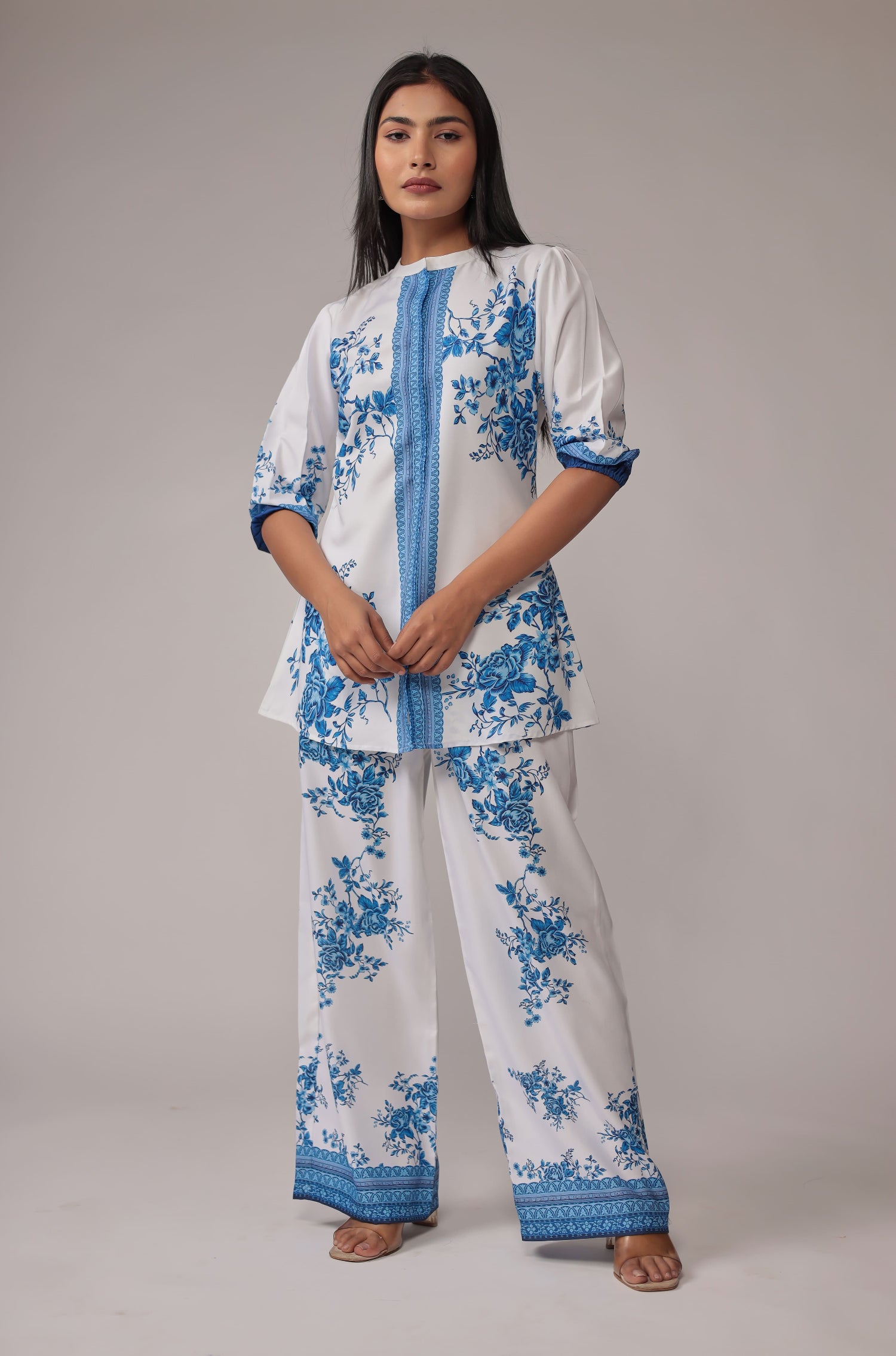 Model wearing an elegant white co-ord set from The Navra, featuring a stunning royal blue digital print kurta and matching wide-leg pants. Perfect for stylish casual or semi-formal occasions.