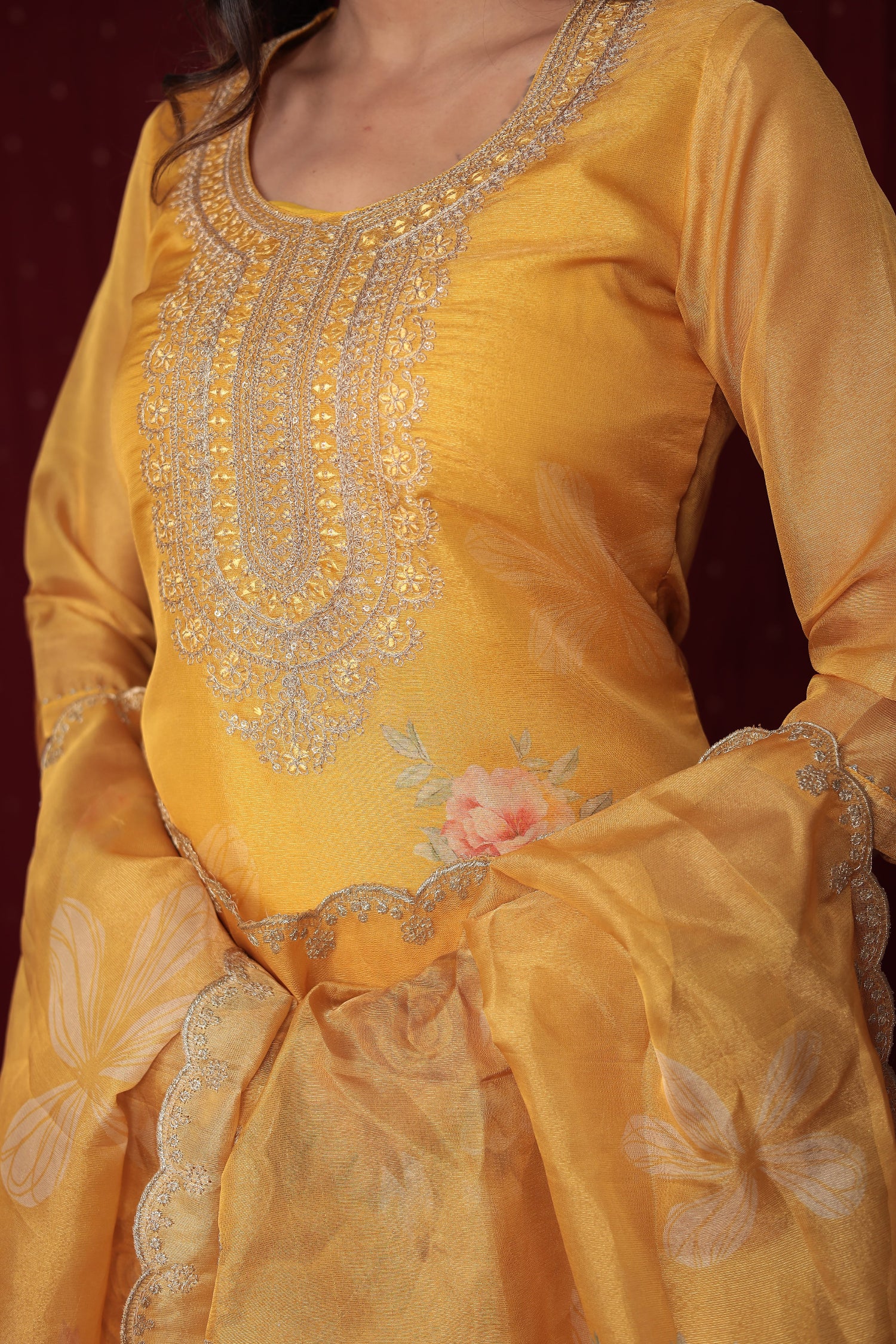 Detailed view of the soft organza dupatta with vibrant floral embroidery and print, paired with the yellow ethnic suit.