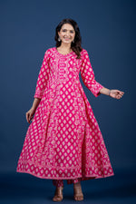 Side profile of model showcasing the voluminous tiered flare and comfortable movement of the fuchsia pink printed Anarkali dress.