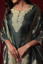Detailed view of the luxurious dark green jacquard dupatta with prominent gold woven patterns and border, complementing the suit.