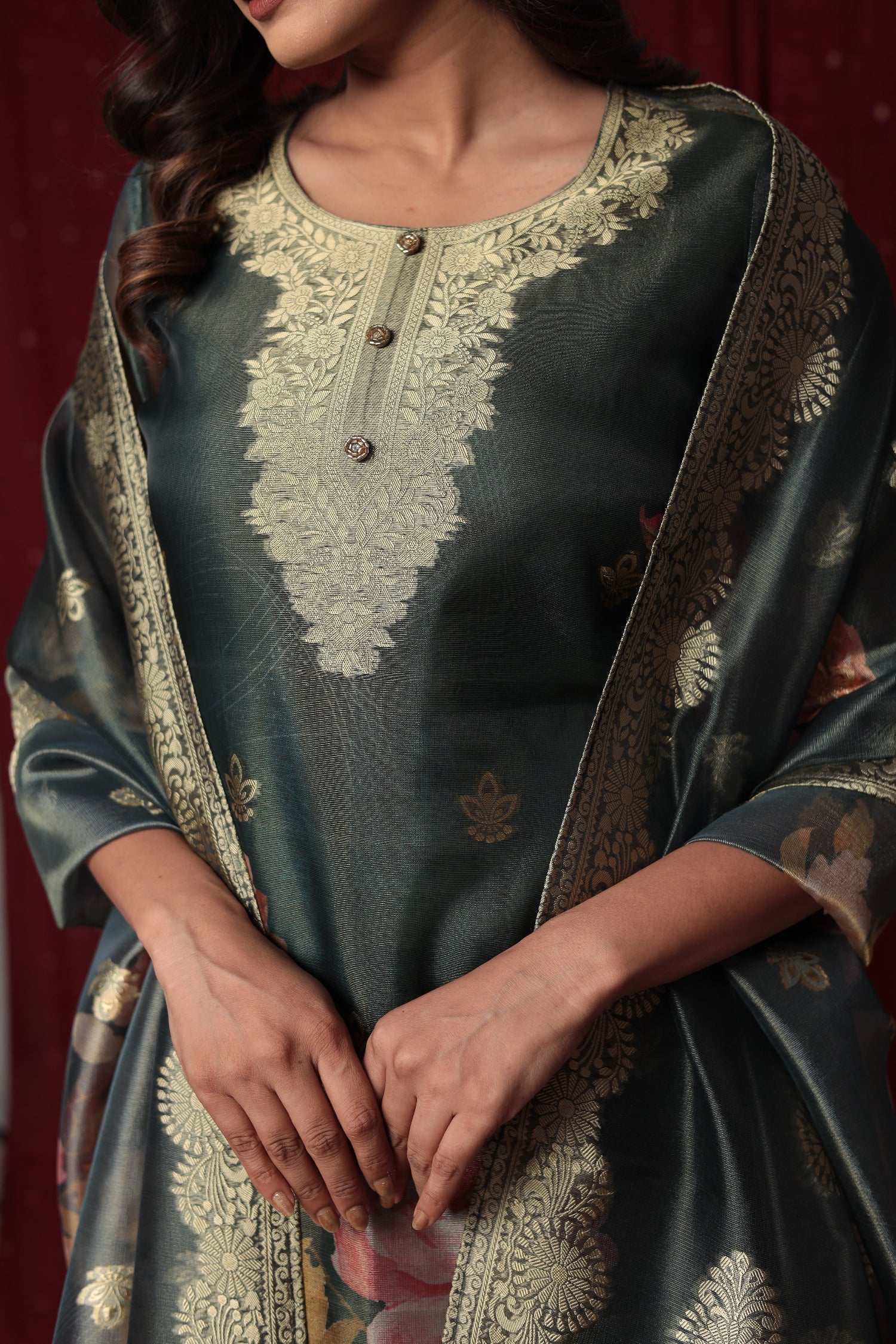 Detailed view of the luxurious dark green jacquard dupatta with prominent gold woven patterns and border, complementing the suit.