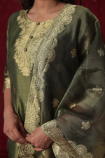 Detailed view of the luxurious olive green jacquard organza dupatta with rich gold woven designs and subtle floral prints, complementing the suit.