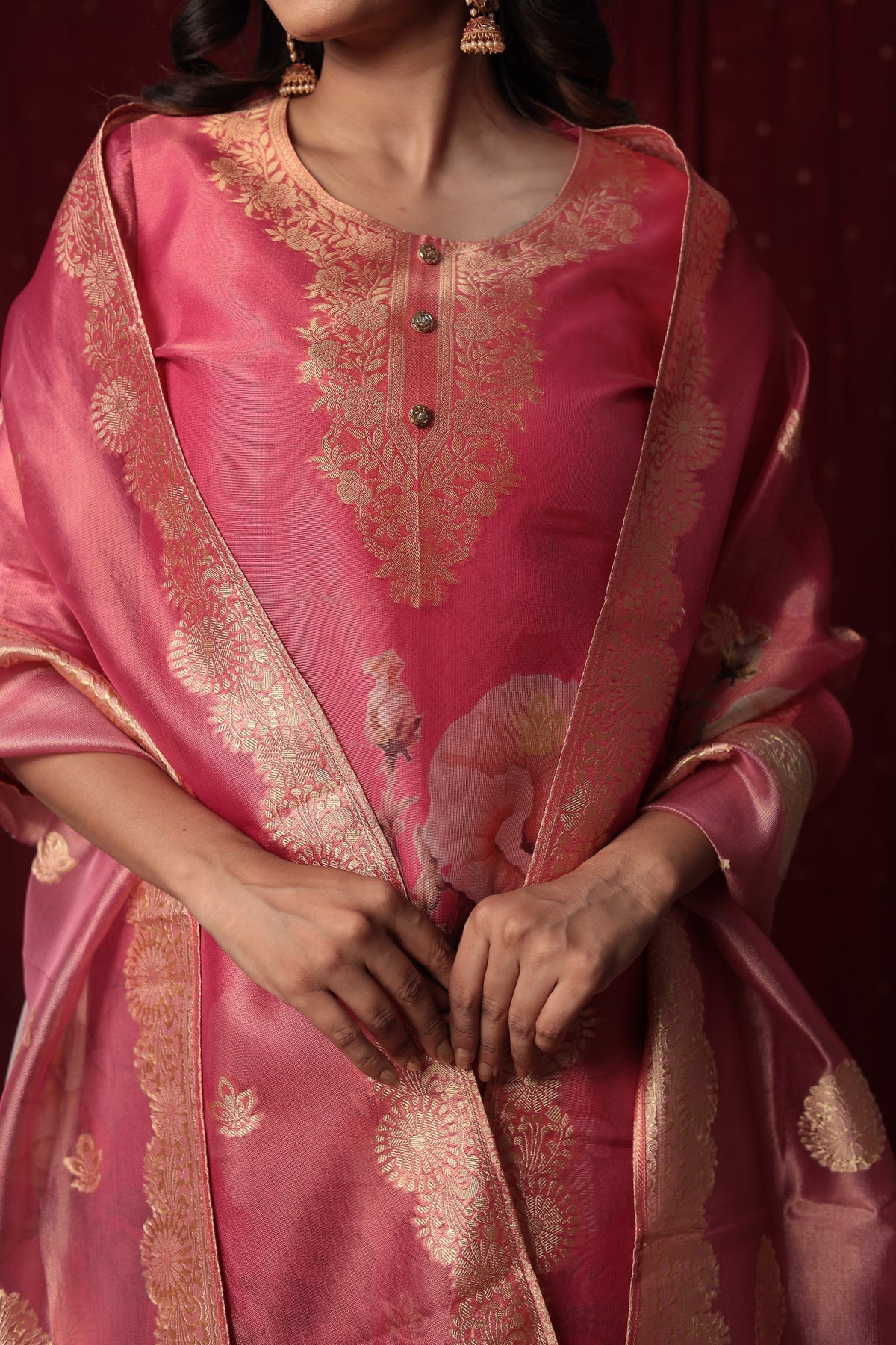 Detailed view of the luxurious pink jacquard organza dupatta with prominent gold woven patterns and floral motifs, complementing the suit.
