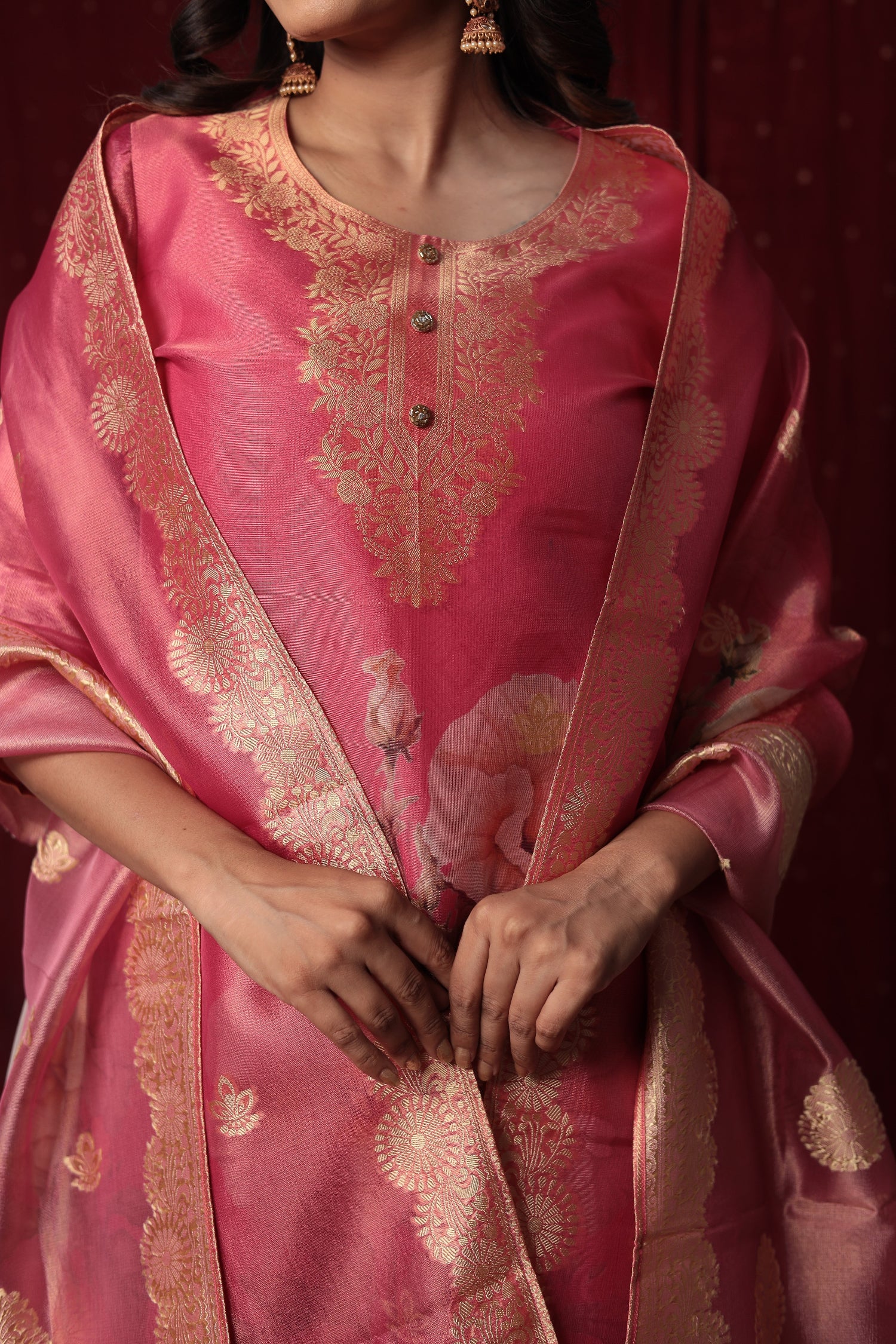 Detailed view of the luxurious pink jacquard organza dupatta with prominent gold woven patterns and floral motifs, complementing the suit.