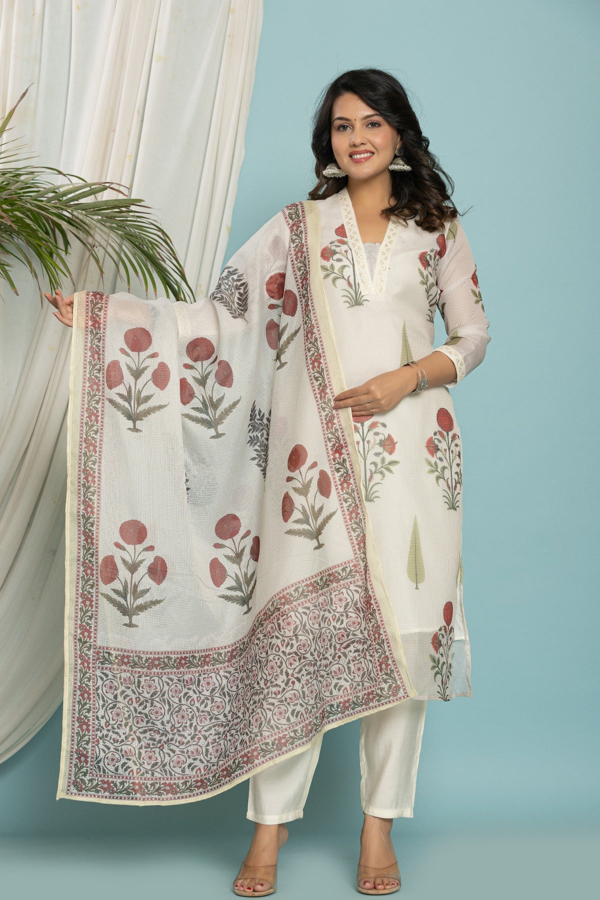 Model wearing white Kota Doria dupatta set from The Navra, featuring a floral print kurti and matching dupatta, with soft silk pants. Ideal for casual or daily wear.