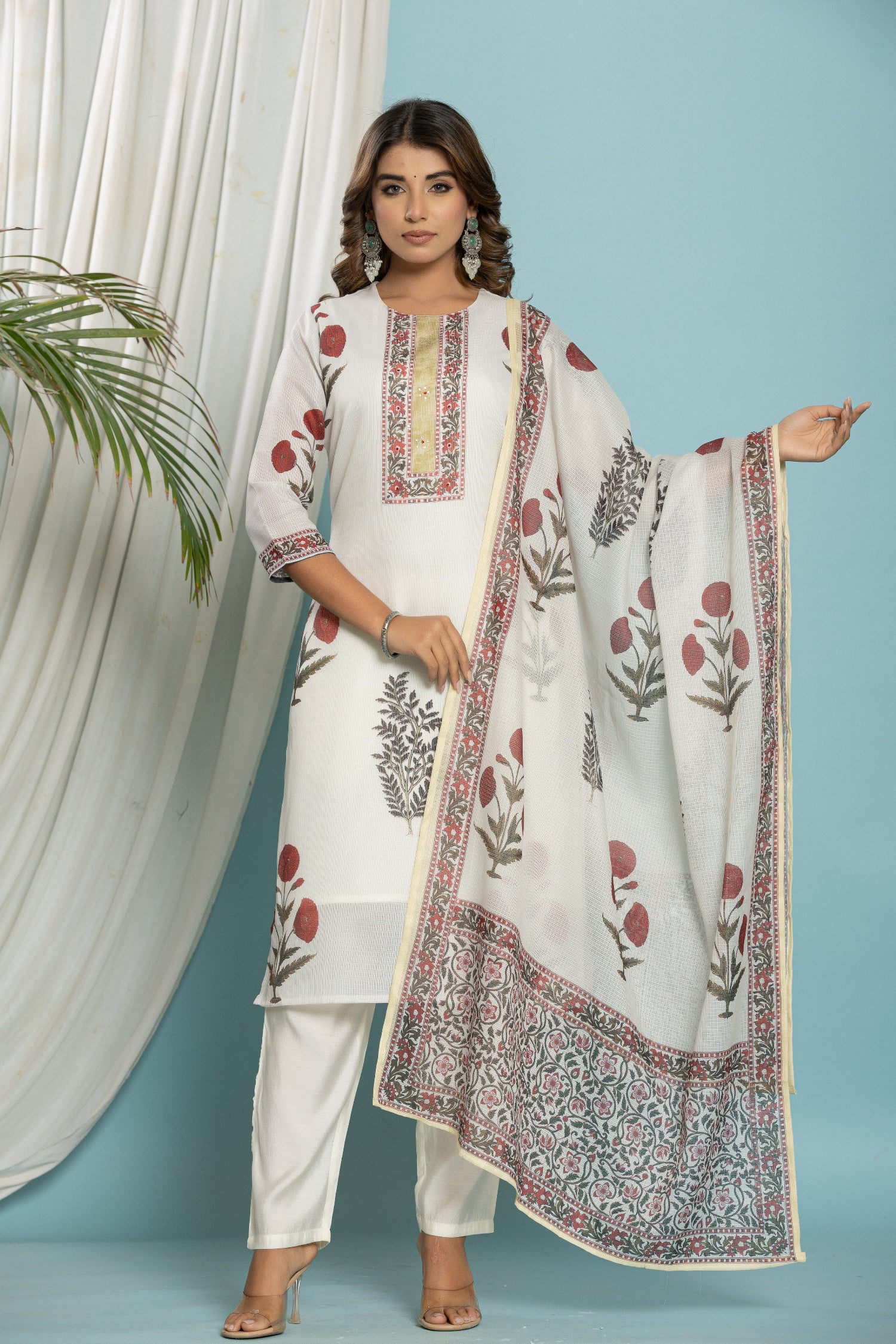 Model wearing off-white Kota Doria dupatta set from The Navra, featuring a red and black floral print kurti, matching dupatta, and soft silk pants. Ideal for casual or everyday ethnic wear.