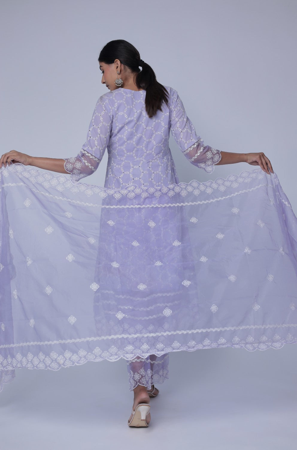 Close-up of the delicate white Chikankari embroidery on the V-neckline of the lavender Anarkali kurta, highlighting intricate details.