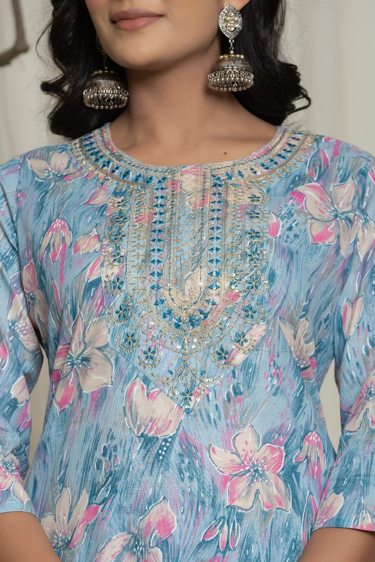 Close-up of the delicate embroidery detailing on the round neckline of the light blue cotton kurti, with visible multicolor mill print.