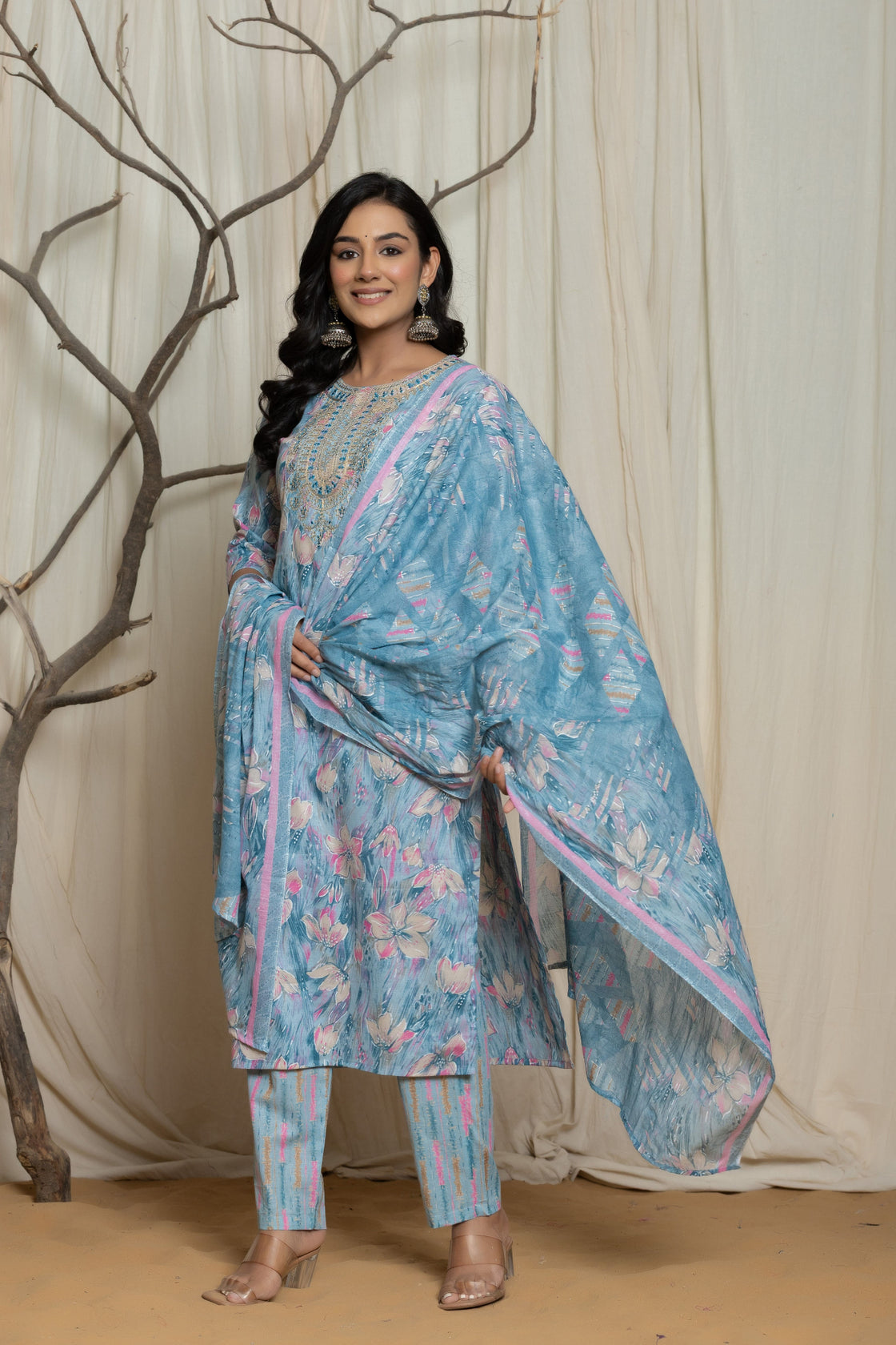 Side profile of model showcasing the comfortable fit and elegant drape of the light blue cotton premium mill print dupatta set with embroidery.