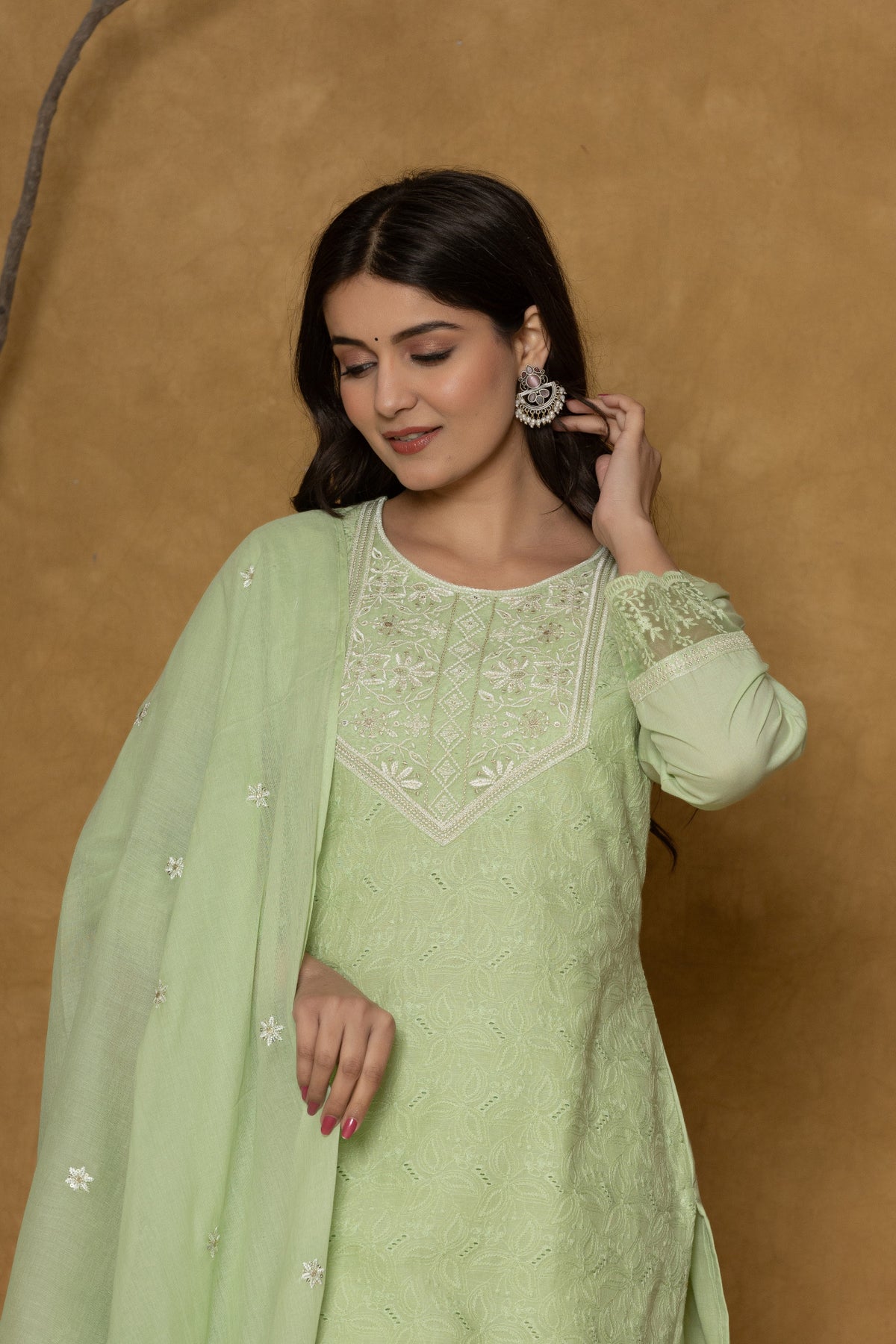 Model gracefully posing in the light green Chifley dupatta set, showcasing the fluidity and elegance of the textured dupatta.