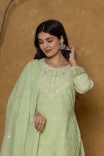 Model gracefully posing in the light green Chifley dupatta set, showcasing the fluidity and elegance of the textured dupatta.