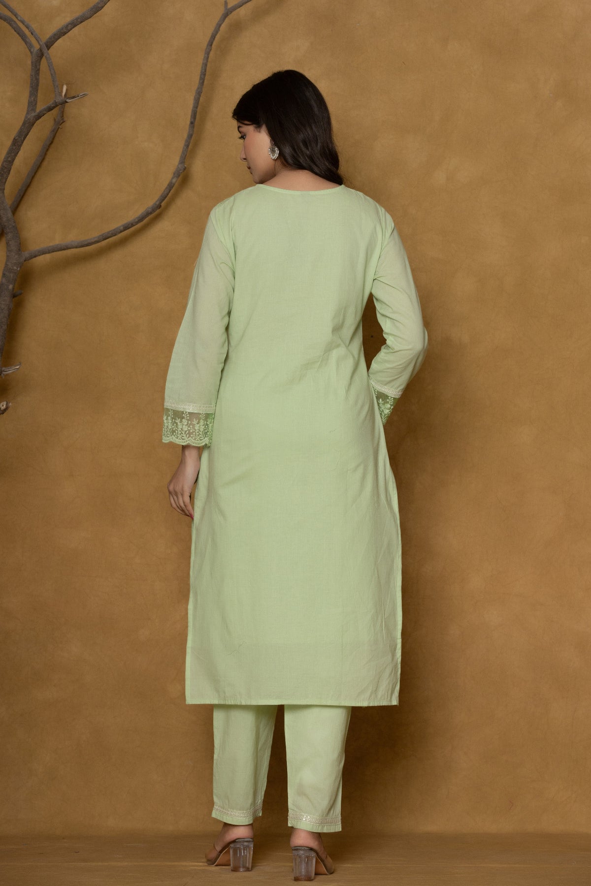 Detailed view of the lower kurti and pant of the light green Chifley cotton set, showcasing the fabric texture and subtle design at the hem.