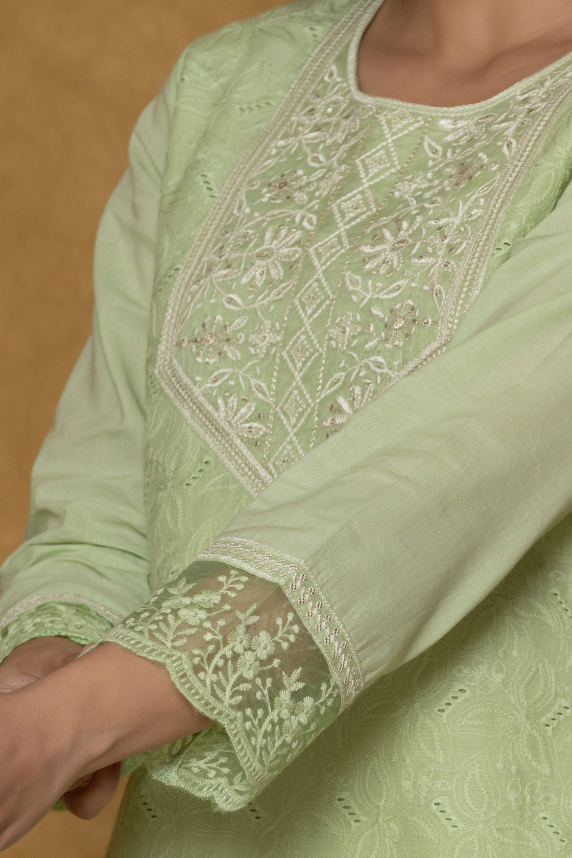 Detailed view of the embroidered cuff and sleeve of the light green cotton kurti, showcasing the delicate Chifley fabric texture.