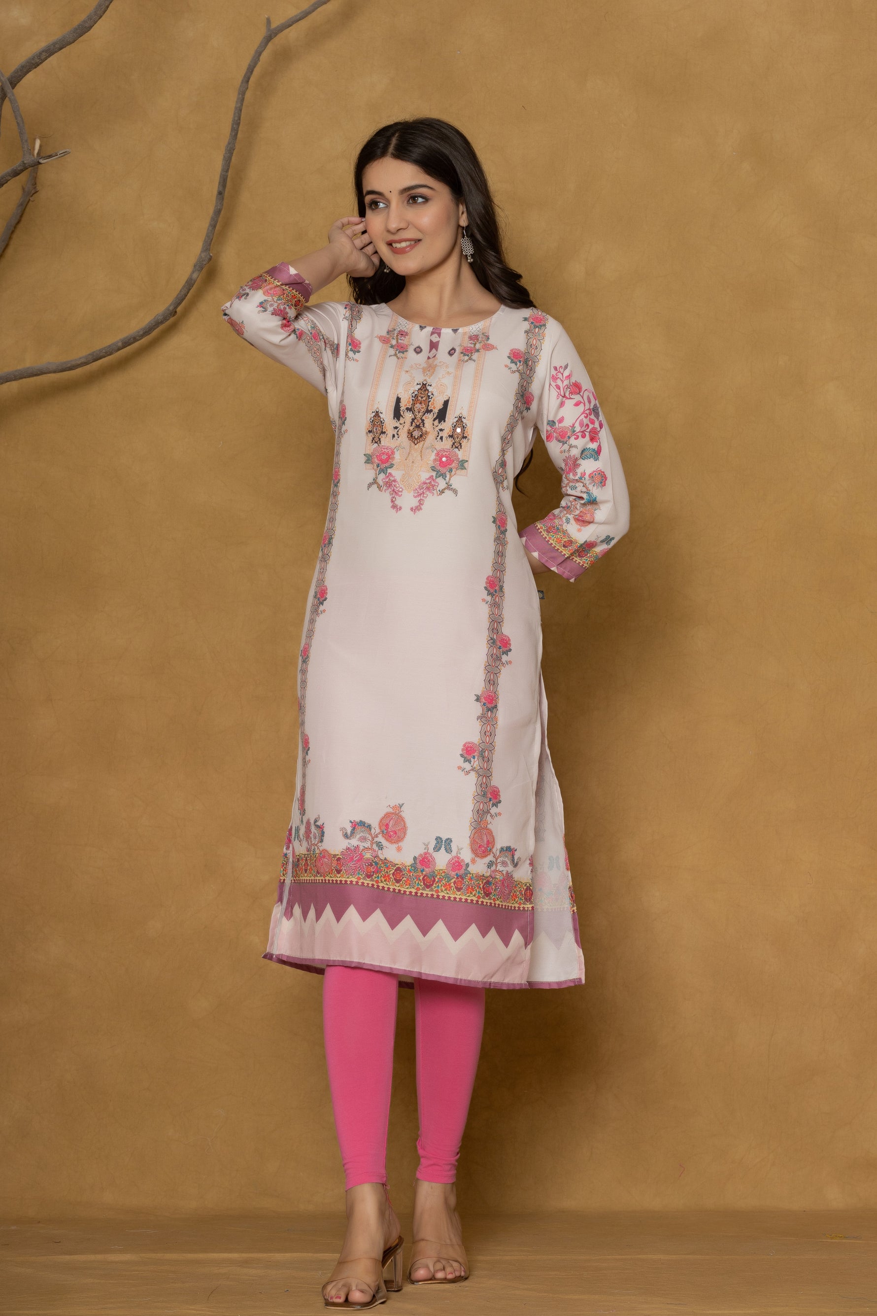 Model in a confident stance, highlighting the full length and overall detailed patterned design of the light pink kurta with handwork.