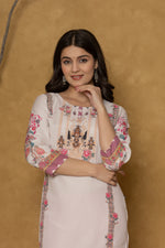 Side profile of model showcasing the comfortable fit and elegant patterned design of the light pink kurta with handwork detailing.