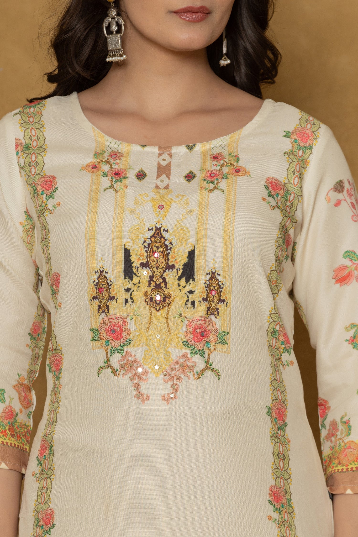 Close-up of the beautiful multi-color handwork embroidery and intricate patterns on the round neckline of the light yellow kurta, highlighting fine craftsmanship.