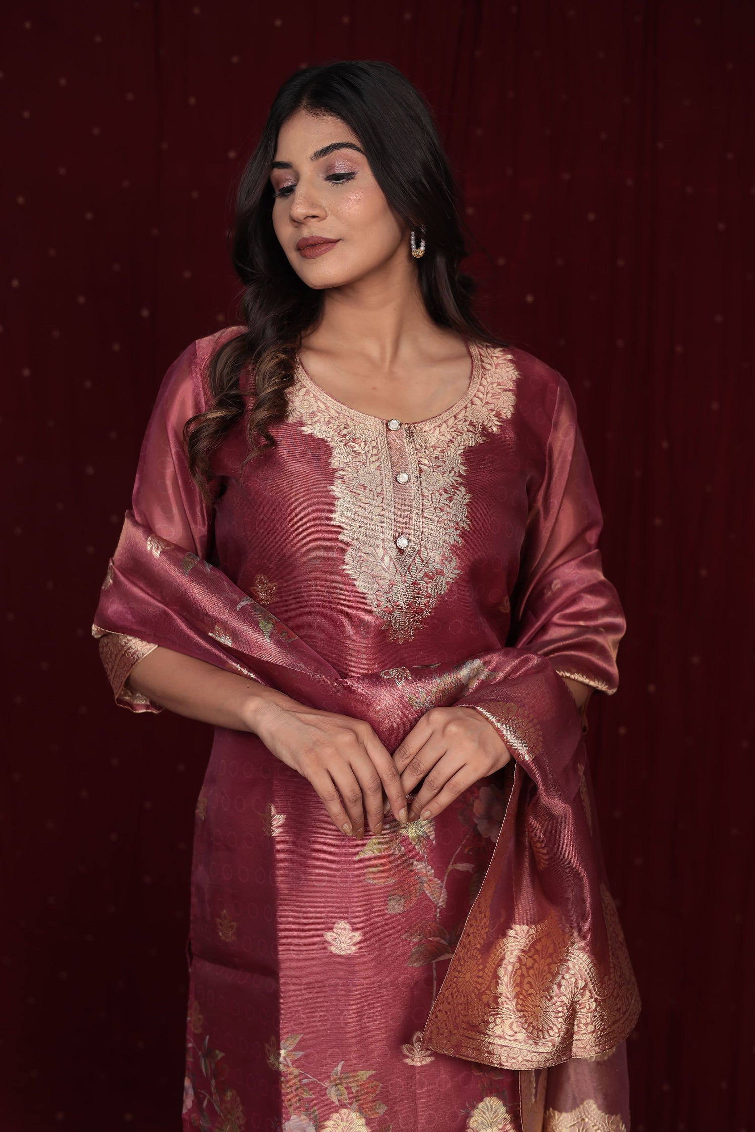 Side profile of model showcasing the elegant drape and luxurious feel of the deluxe jacquard organza maroon suit.