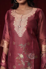 Close-up of the exquisite gold embroidery on the neckline and subtle woven jacquard patterns on the rich maroon organza kurti.