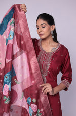 Side profile of model showcasing the elegant drape of the printed jacquard dupatta and the flattering fit of the maroon soft silk suit set.